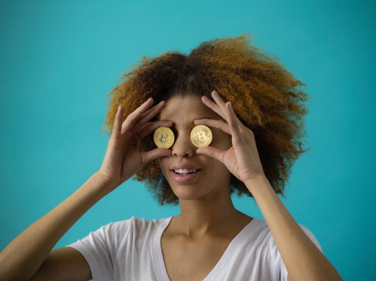 woman putting coins in front of her eyes